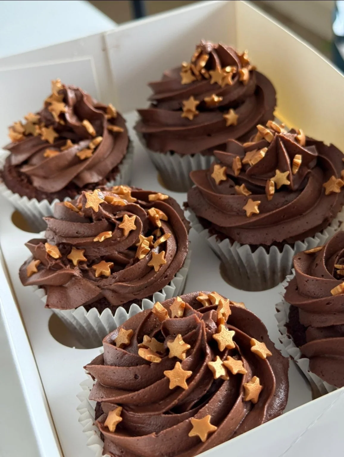 Chocolate cupcakes with gold star sprinkles